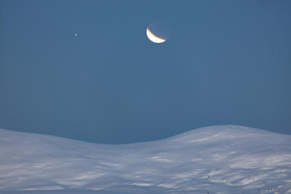 Moon eclipse on the snowy landscape, Troms, Norway