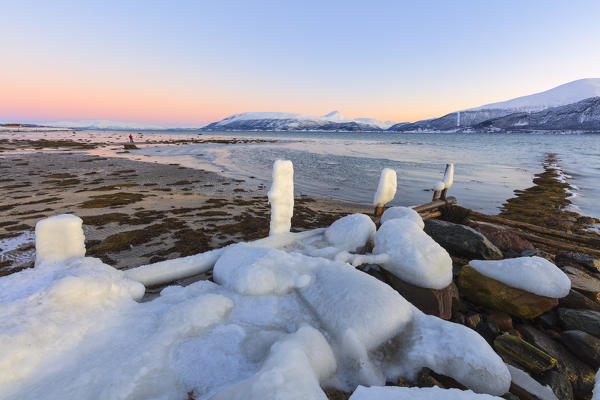 Fence covered with snow on the beach, Troms, Norway