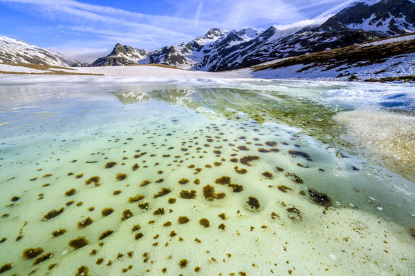 Turquoise water of Lake Andossi during thaw, Chiavenna Valley, Spluga Valley, Sondrio province, Valtellina, Lombardy, Italy