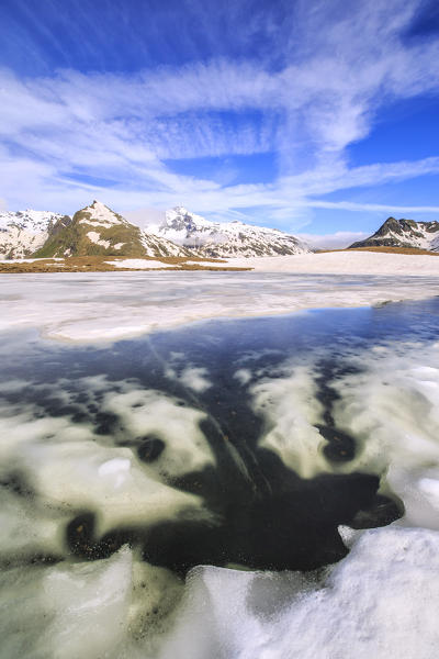 Ice melting at Lake Andossi during spring thaw, Chiavenna Valley, Spluga Valley, Sondrio province, Valtellina, Lombardy, Italy