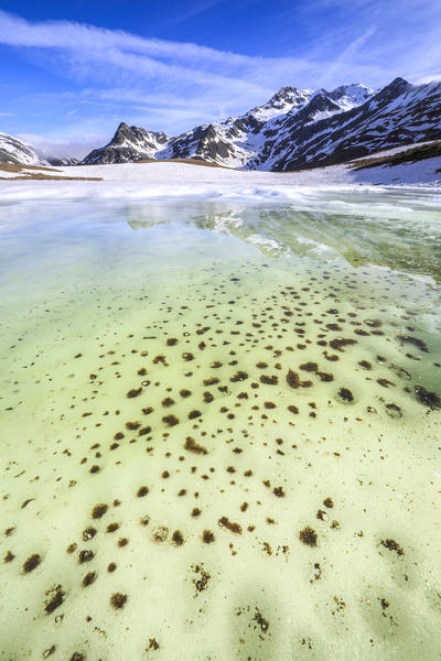 Turquoise water of Lake Andossi during thaw, Chiavenna Valley, Spluga Valley, Sondrio province, Valtellina, Lombardy, Italy