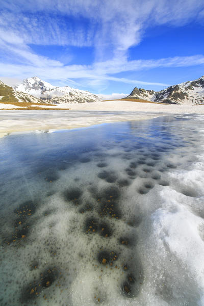 Ice melting at Lake Andossi during spring thaw, Chiavenna Valley, Spluga Valley, Sondrio province, Valtellina, Lombardy, Italy