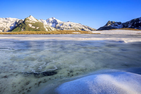 Ice melting at Lake Andossi during thaw, Chiavenna Valley, Spluga Valley, Sondrio province, Valtellina, Lombardy, Italy