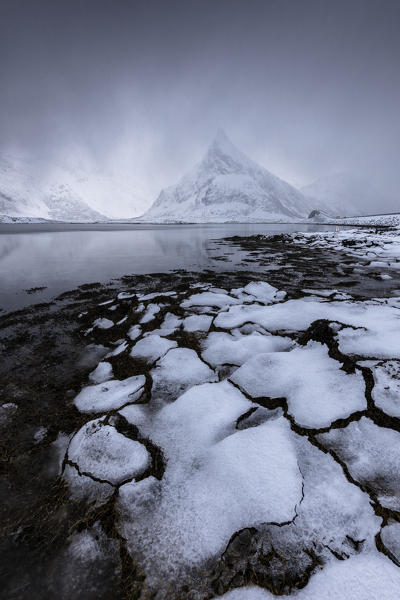 Mist on the snowy peak of Volanstinden, Fredvang, Lofoten Islands, Norway