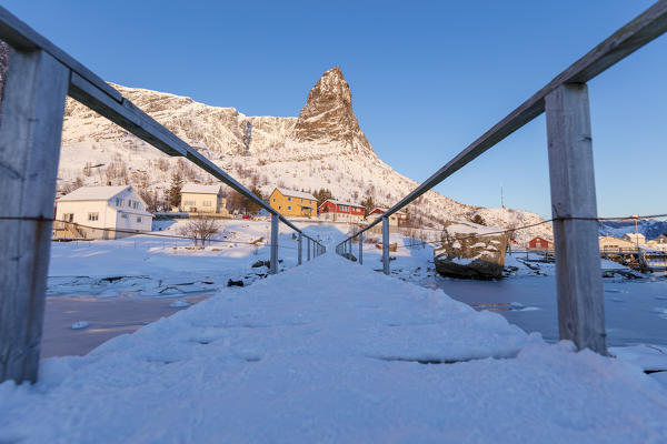 Footbridge on the icy sea, Reine Bay, Lofoten Islands, Norway