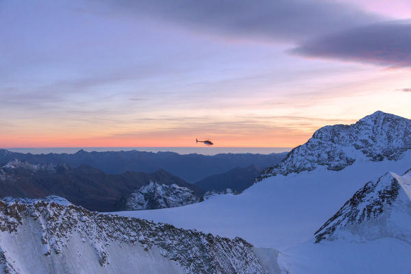 Aerial view of helicopter in flight on peaks of the Bernina Group, border of Italy and Switzerland