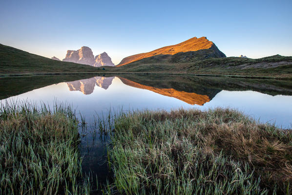 Lake Baste at sunrise reflecting the massive mount Pelmo - Zoldo group, Dolomites of Belluno, province of Belluno, Veneto, Italy. Europe