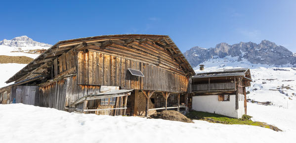 Panoramic of wood hut surrounded by snow, Partnun, Prattigau, Davos, canton of Graubunden, Switzerland