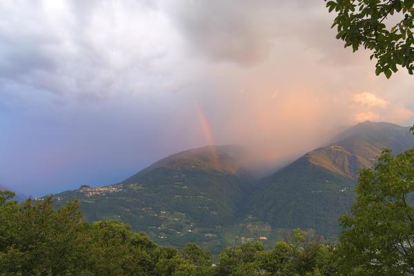 Rainbow at sunrise, Teglio, Sondrio province, Valtellina, Lombardy, Italy