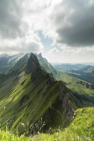 Clouds on the rocky crest of Santis and green valley seen from Schafler, Appenzell Innerrhoden, Switzerland