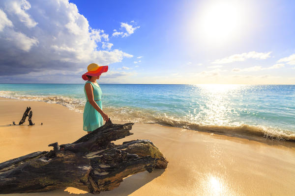 Woman with hat looks at the crystal sea, Ffryes Beach, Antigua, Antigua and Barbuda, Caribbean, Leeward Islands, West Indies