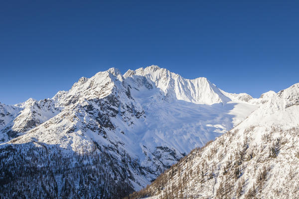 Sunrise on the snowy peak of Monte Vazzeda, Alpe dell'Oro, Valmalenco, Valtellina, Sondrio province, Lombardy, Italy