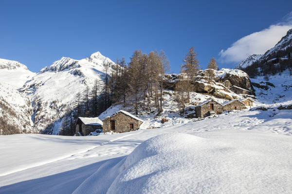 Stone huts covered with snow, Alpe dell'Oro, Valmalenco, Valtellina, Sondrio province, Lombardy, Italy