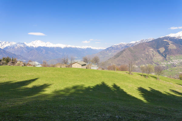 Huts in the green meadows during spring, Corte, Valgerola, Valtellina, Sondrio province, Lombardy, Italy