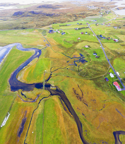 Aerial panoramic of winding creek among green fields, Fredvang, Nordland county, Lofoten Islands, Norway