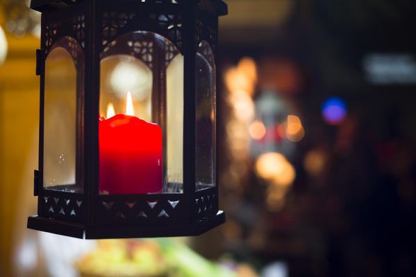 a close up image of a red candle during the Christmas market in the village of Klausen, Bolzano province, South Tyrol, Trentino Alto Adige, Italy, Europe