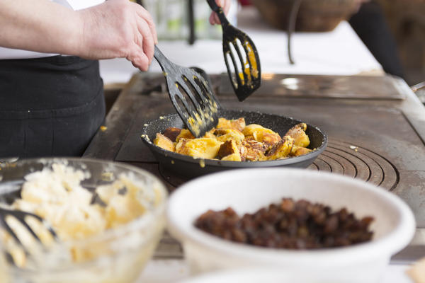 a close up of a cook cooking the Kaiserschmarrn, a typical south tyrolean food, Bolzano province, South Tyrol, Trentino Alto Adige, Italy, Europe