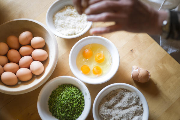 a Chef is preparing a traditional local food with eggs, Bolzano province, South Tyrol, Italy