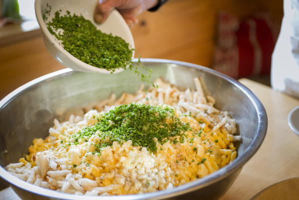 a Chef is preparing a traditional local food with eggs, brot, and chives, Bolzano province, South Tyrol, Italy