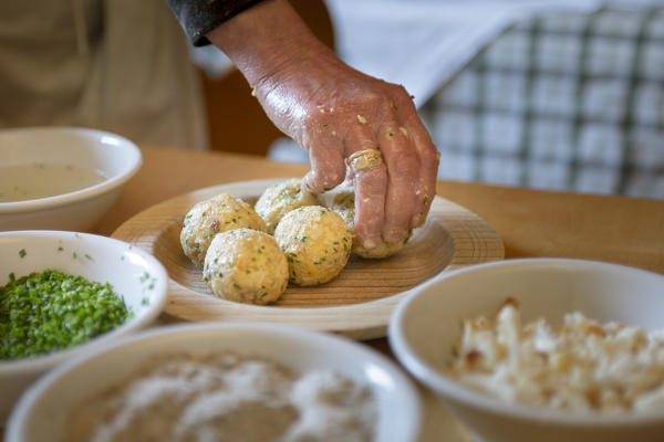 a chef has finished some of homemade dumplings, (canederli), Bolzano province, South Tyrol, Trentino Alto Adige, Italy, 