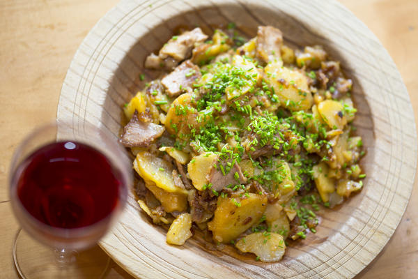 a plate of gröstl, a typical tyrolean food with meat, onions, chives and potatoes, Bolzano province, South Tyrol, Trentino Alto Adige, Italy, 