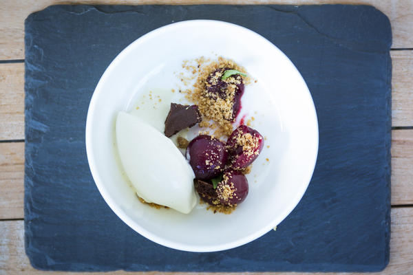mise en place of a dessert with iced mousse, crunchy hazelnuts and cherries, bolzano province, south tyrol, trentino alto adige, italy