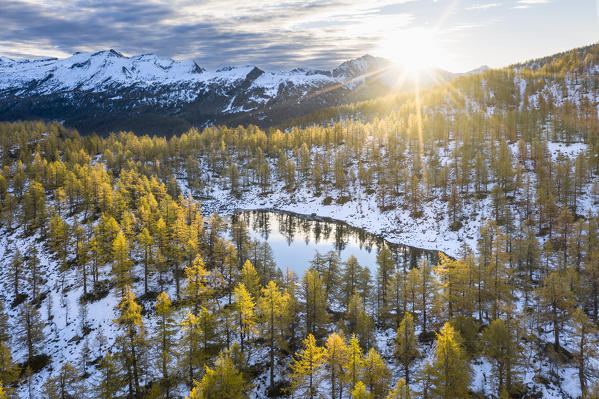 Aerial view of the Nero Lake in autumn at sunrise (Buscagna Valley, Alpe Devero, Alpe Veglia and Alpe Devero Natural Park, Baceno, Verbano Cusio Ossola province, Piedmont, Italy, Europe)