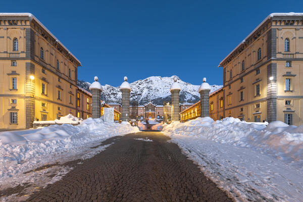 The entrance gate of the Marian Sanctuary of Oropa after an heavy snowfall at morning twilight (Biella, Biella province, Piedmont, Italy, Europe)