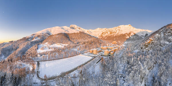 Panoramic view of the Oropa Valley: the Marian Sanctuary of Oropa after an heavy snowfall at sunrise (Biella, Biella province, Piedmont, Italy, Europe)