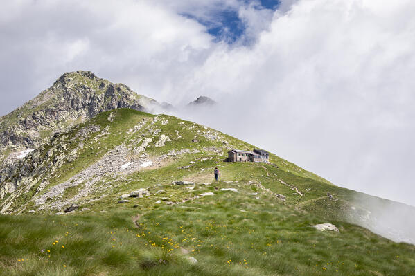 A girl is walking along the Alta Via n. 1 of Aosta Valley towards the Coda Refuge (Pollone, Biella province, Piedmont, Italy, Europe) (MR)