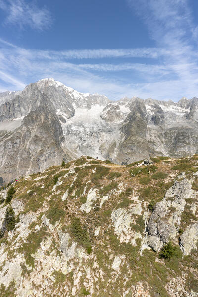 A man at the top of the Mont Chétif in front of Mont Blanc (Veny Valley, Courmayeur, Aosta province, Aosta Valley, Italy, Europe)