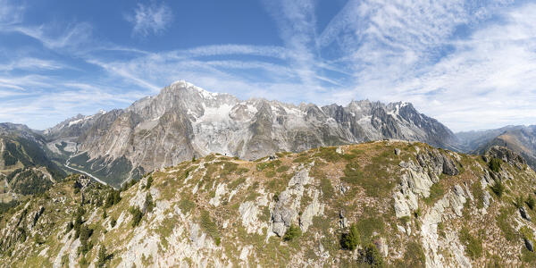 A man at the top of the Mont Chétif in front of Mont Blanc Massif (Veny Valley, Courmayeur, Aosta province, Aosta Valley, Italy, Europe)