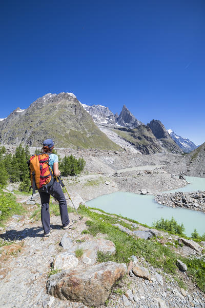 A girl looks Miage lake and Mont Blanc Massif (Miage Lake, Veny Valley, Courmayeur, Aosta province, Aosta Valley, Italy, Europe)