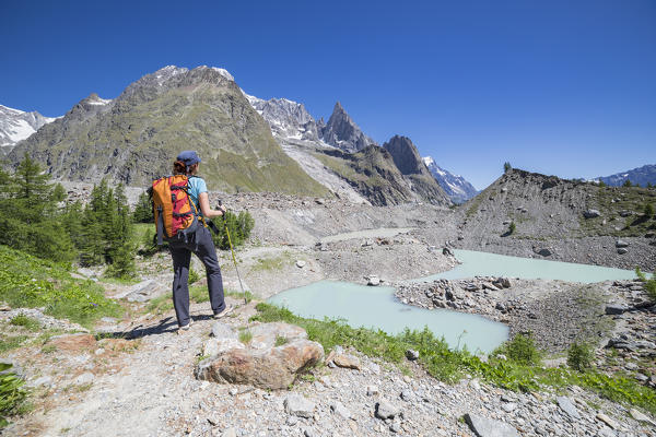 A girl looks Miage lake and Mont Blanc Massif (Miage Lake, Veny Valley, Courmayeur, Aosta province, Aosta Valley, Italy, Europe)