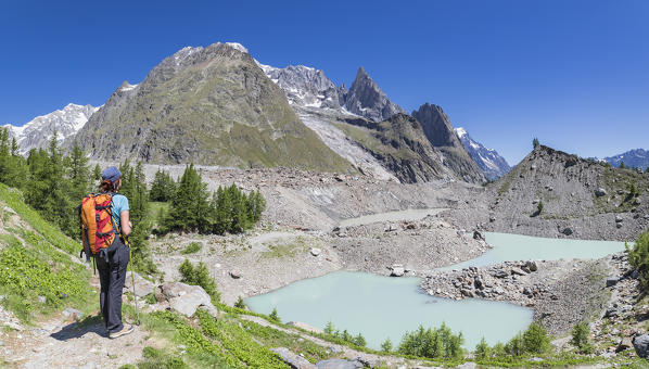 A girl looks Miage lake and Mont Blanc Massif (Miage Lake, Veny Valley, Courmayeur, Aosta province, Aosta Valley, Italy, Europe)