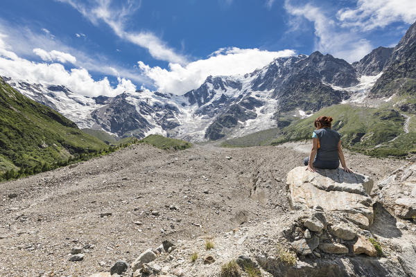 A girl enjoy in front of the East face of the Monte Rosa Massif and the Belvedere Glacier (Belvedere, Macugnaga, Anzasca Valley, Verbano Cusio Ossola province, Piedmont, Italy, Europe)