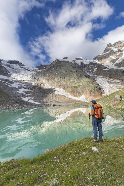 A girls looks the Locce Lake and the Grober Glacier at the foot of the East face of Monte Rosa Massif (Locce Lake, Macugnaga, Anzasca Valley, Verbano Cusio Ossola province, Piedmont, Italy, Europe)