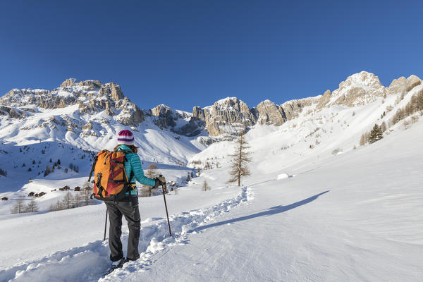 A trekker is looking at Fuciace, a small village in Dolomites near San Pellegrino Pass (Soraga di Fassa, Biois Valley, Trento province, Trentino-Alto Adige, Italy, Europe) (MR)