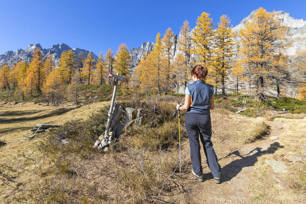 A girl is watching a sing near the Nero Lake in the Alpe Veglia and Alpe Devero Natural Park (Buscagna Valley, Alpe Devero, Baceno, Verbano Cusio Ossola province, Piedmont, Italy, Europe) (MR)