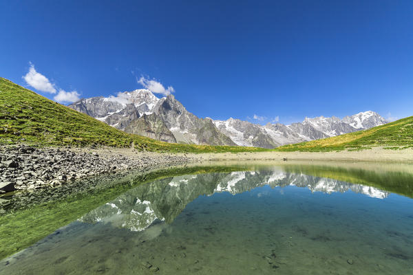 The Mont Blanc Massif reflected in the Checrouit Lake during the Mont Blanc hiking tours (Veny Valley, Courmayeur, Aosta province, Aosta Valley, Italy, Europe)
