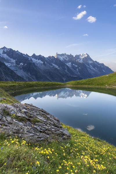 The Mont Blanc Massif reflected in the Checrouit Lake at sunset during the Mont Blanc hiking tours (Veny Valley, Courmayeur, Aosta province, Aosta Valley, Italy, Europe)
