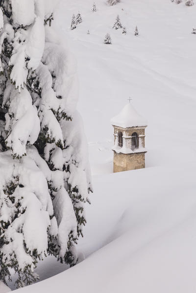 Bell tower of San Bernardo alpine church in a winter landscape after a snowfall. Rezzalo valley, SOndalo, Sondrio district, Valtellina, Alps, Lombardy, Italy, Europe.