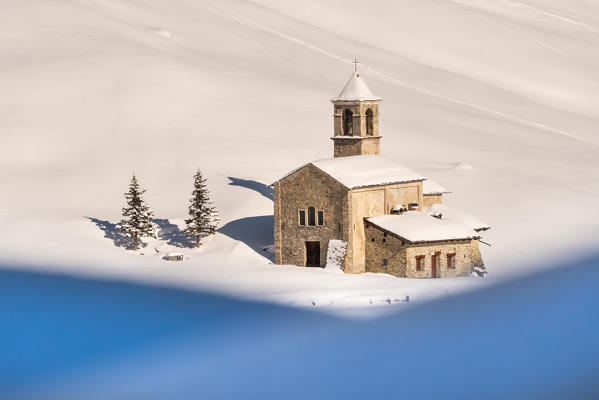 Close up of San Bernardo alpine church into the snow during winter . Rezzalo valley, SOndalo, Sondrio district, Valtellina, Alps, Lombardy, Italy, Europe.