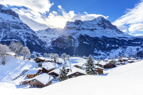 Traditional houses after a snowfall. Grindelwald, Canton of Bern, Switzerland, Europe.