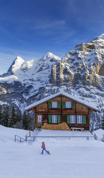 A child walks on the snow. Murren, Lauterbrunnen valley, Canton of Bern, Switzerland, Europe.