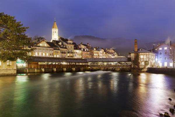 Historical center is reflected in the Aare river at dusk. Thun, Canton of Bern, Switzerland, Europe.