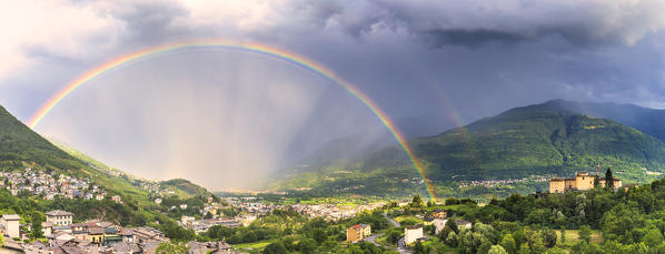 Panoramic view of the rainbow above the valley. Valtellina, Lombardy, Italy, Europe.