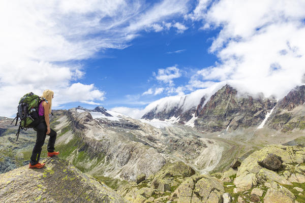 A girl looks the landscape. Valmalenco, Valtellina, Lombardy, Italy, Europe.