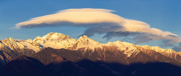 Panoramic view of Disgrazia group with lenticular clouds at sunset. Valtellina, Sondrio province, Italy, Europe.