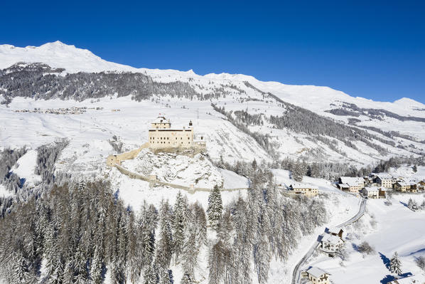 Aerial view of Tarasp castle after snowfall. Tarasp, Lower Engadine, Canton of Grisons, Switzerland, Europe.